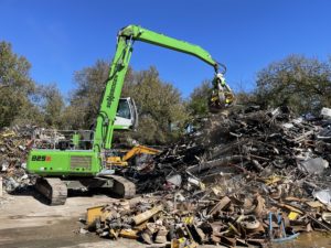 An excavator at a metal recycling yard in Dallas, TX