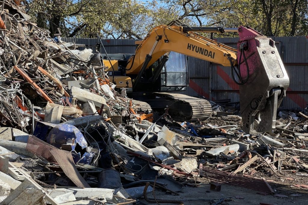 An excavator sorting for metal recycling in Dallas, TX