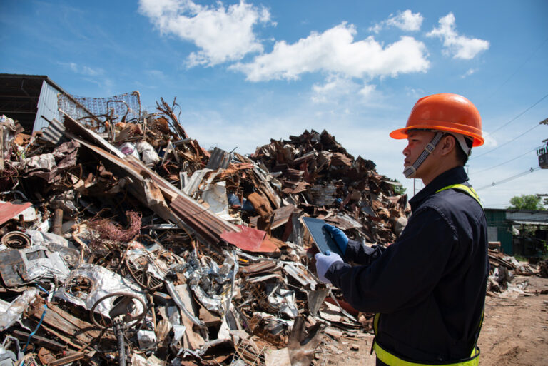 scrap yard associate working on mobile tablet